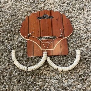 Hoop earrings with white shells.